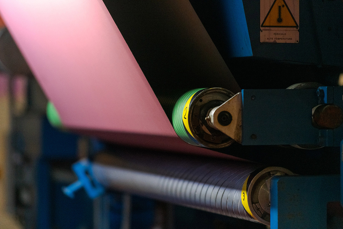 Documentary manufacturing photography close up of machinery during the Ambla fabric production process.