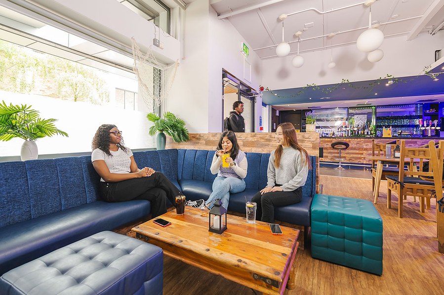 student lifestyle photography, wide shot of students at in a bar area on campus