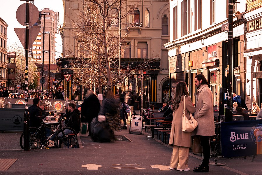 placemaking photography. manchester. norther quarter. architecture. couple stood near busy square