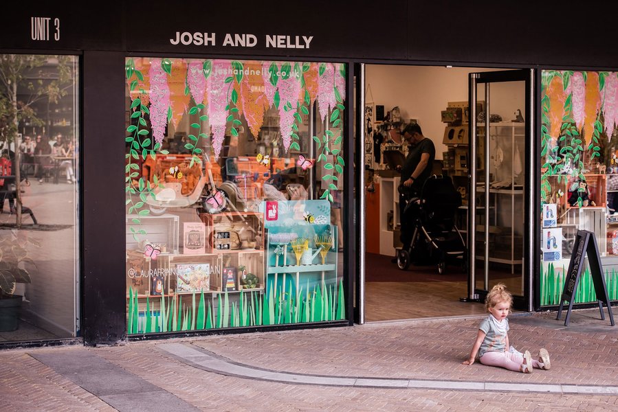 Placemaking and lifestyle photography,
Leisure and hospitality destination,
toddler sat outside a shop