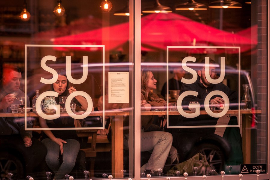 placemaking photography. manchester. norther quarter. architecture. looking at window of Italian restaurant
