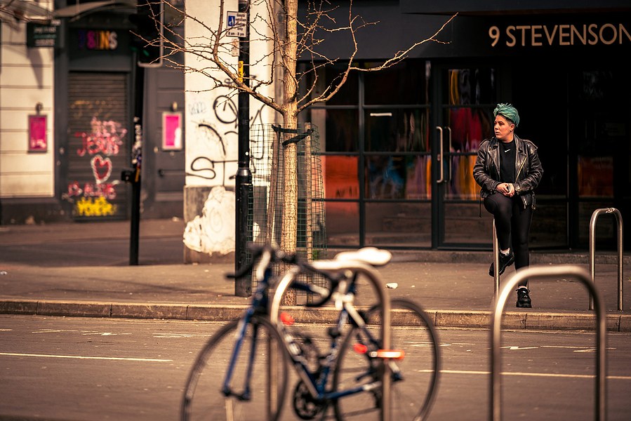 placemaking photography. manchester. norther quarter. architecture. bike. person in background sitting and looking to the side