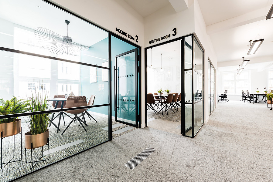 photograph looking into Meeting room in refurbished manchester office building. modern design with blue walls and wooden floor.