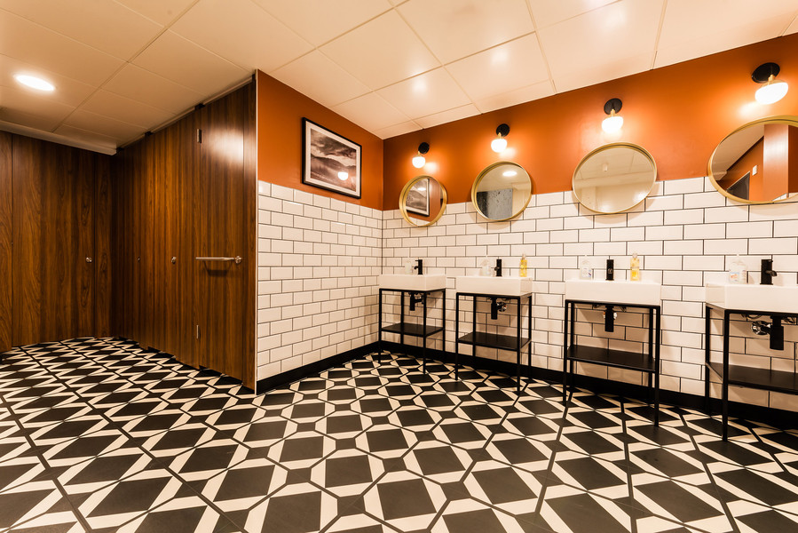 tiled toilets in manchester office building. modernised interior and premium tiles