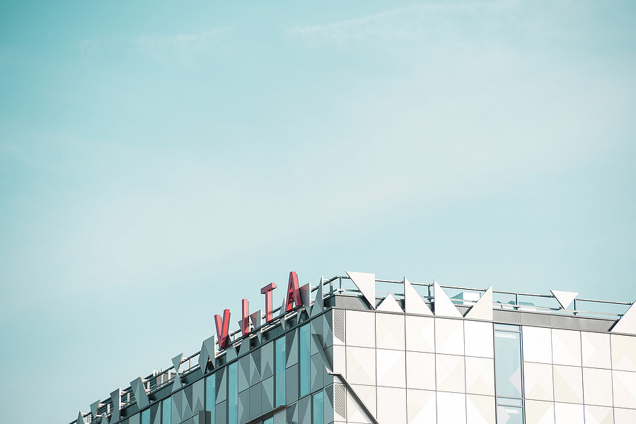 cropped image of modern city buildings against blue sky