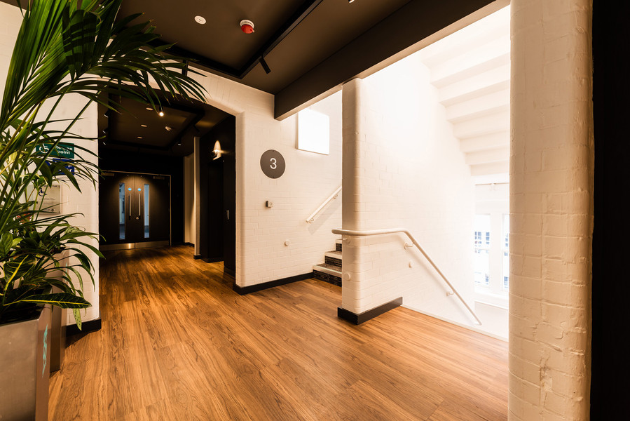 entrance and stairwell in manchester office building. wooden floors and plants feature