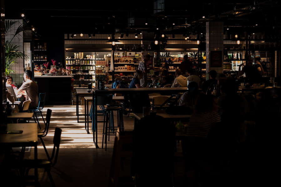 Placemaking and lifestyle photography,
Leisure and hospitality destination,
Customers sat inside cafe lit by sunlight