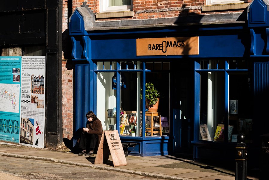 stockport lifestyle and placemaking photography, shopper waiting outside local record shop