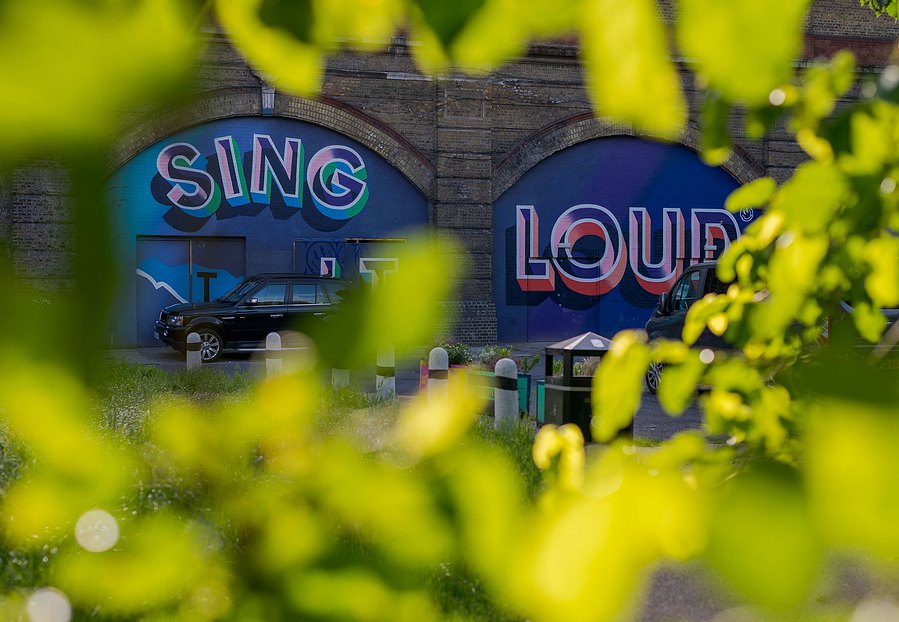 london lifestyle photography, cropped shot of signs saying sing and loud