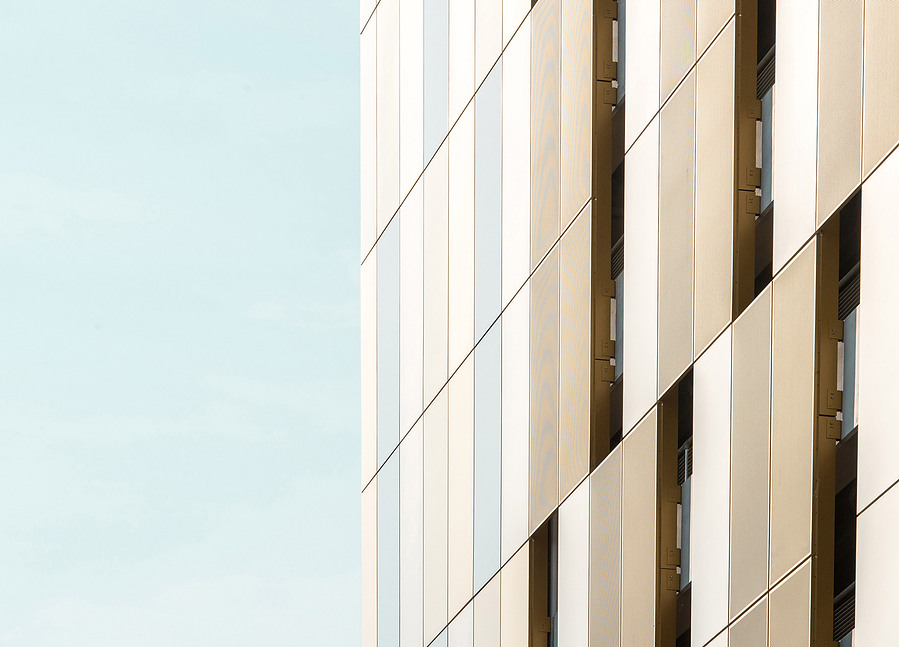 cropped image of modern city buildings against blue sky