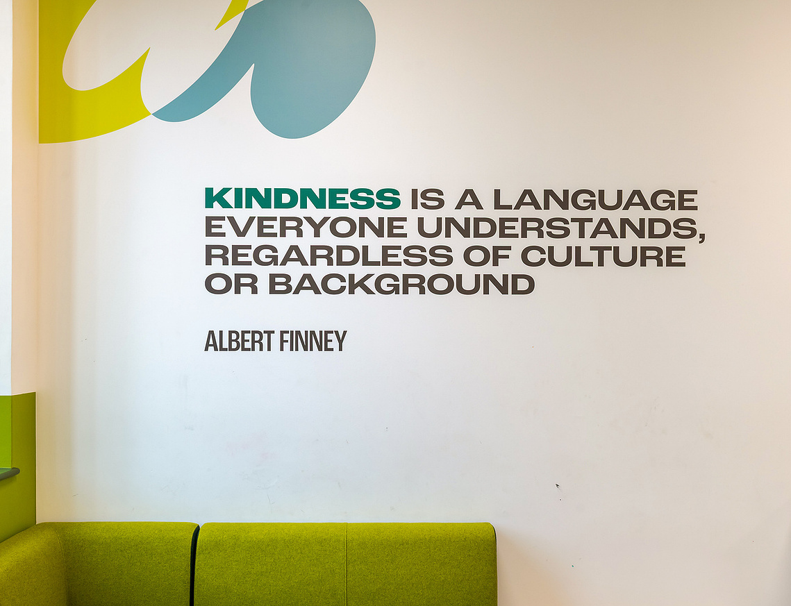 Detail shot by commercial interior photographer Manchester, showcasing a close up of high quality graphic installations with famous quote, shown in context with space