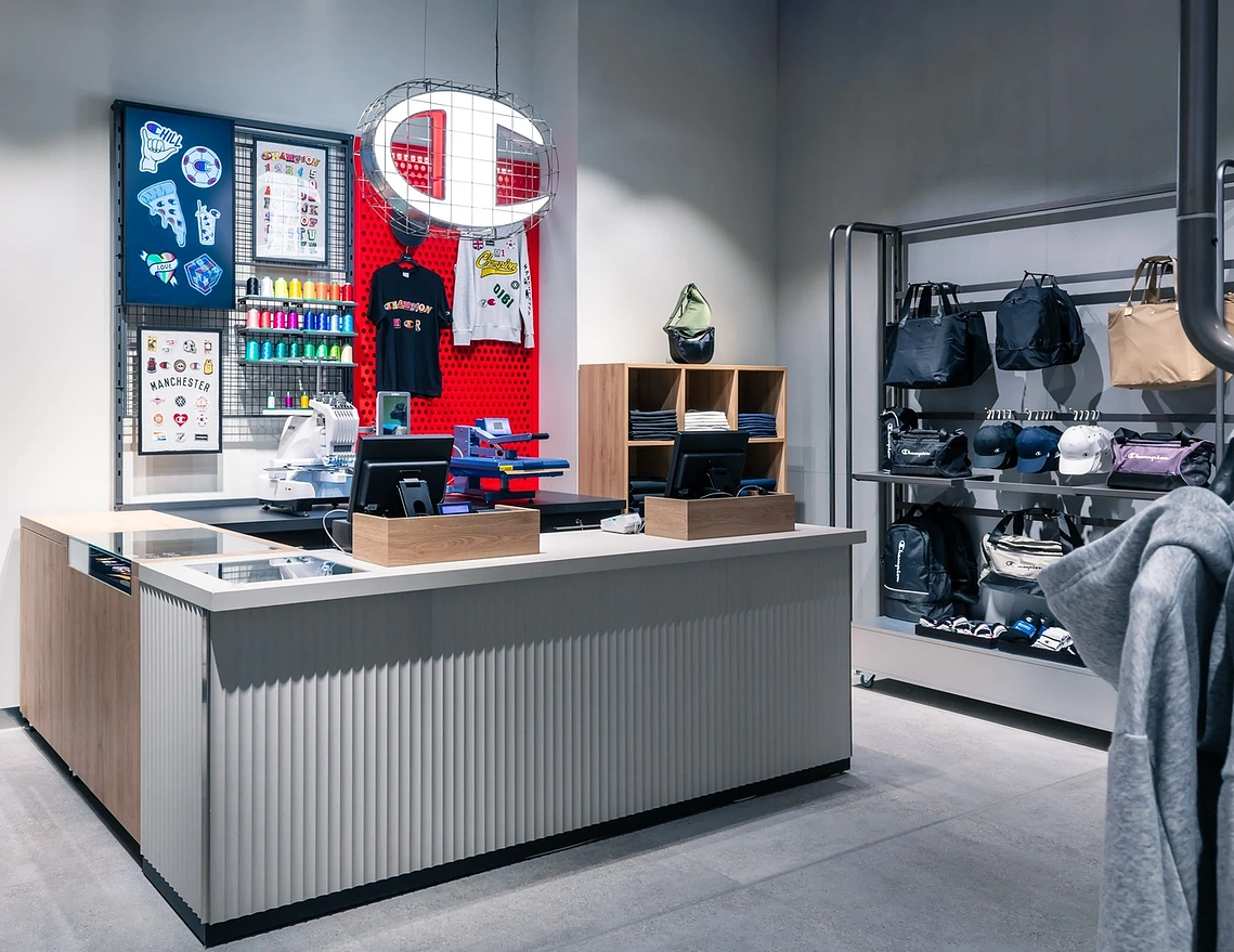Commercial interior photograph of the customisation station feature area in a Manchester retail space.