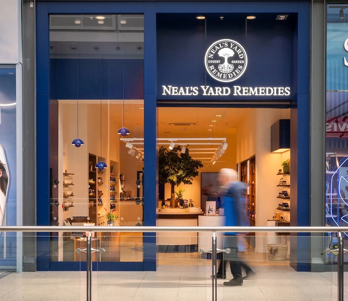 Commercial retail photography of the Neal's Yard concept store facade in Manchester Arndale with shoppers
