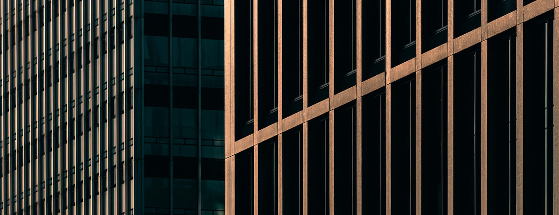 professional abstract architecture photography cityscape cropped image of hi-rise buildings skyscrapers evening golden light geometric