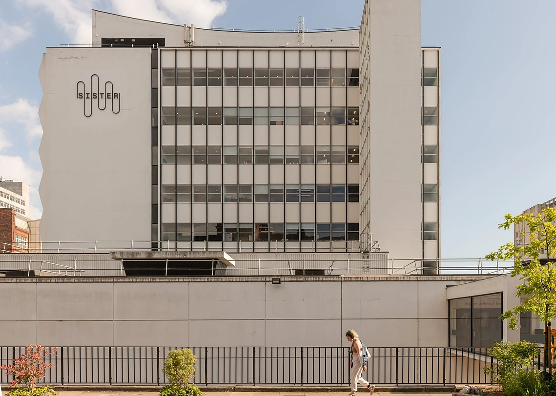 Exterior architecture photography of Renold Building in Manchester against a blue sky.