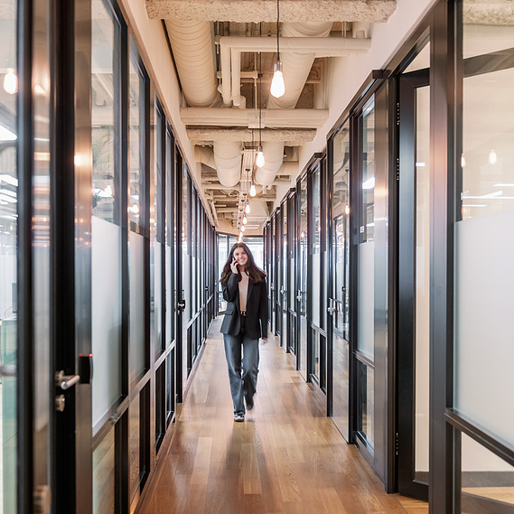 Brand storytelling through lifestyle photography, worker on phone in corridor