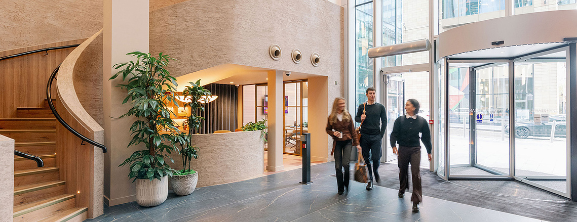 Lifestyle photography of professionals arriving at 3 Hardman Street reception in Manchester