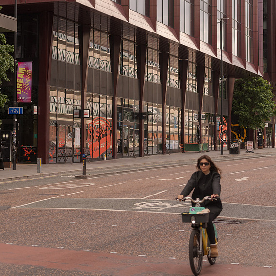 exploring how architecture interacts with natural light.	street manchester, Oxford road, cyclist