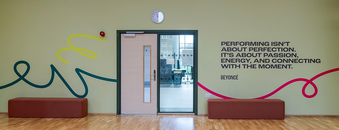 Architectural vinyl photography showcasing custom wall graphics and inspirational quotes installed on a commercial interior wall.