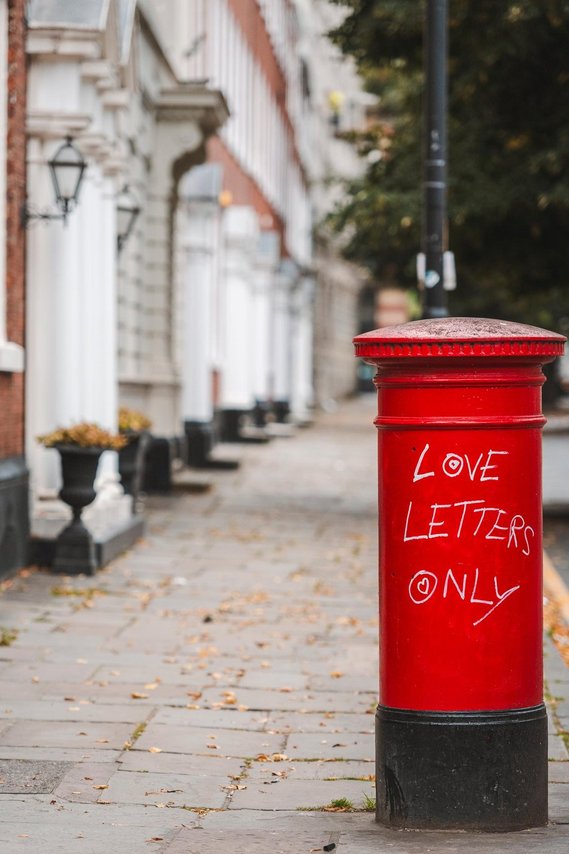 URBAN LIFESTYLE AND LOCAL AREA PHOTOGRAPHY OF SPINNINGFIELDS, MANCHESTER, postbox that has been vandalised with positive message