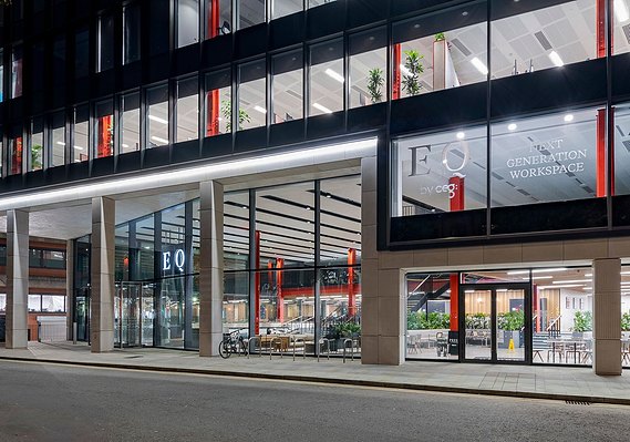 Architectural photography showing frontage of a modern glass building at night
