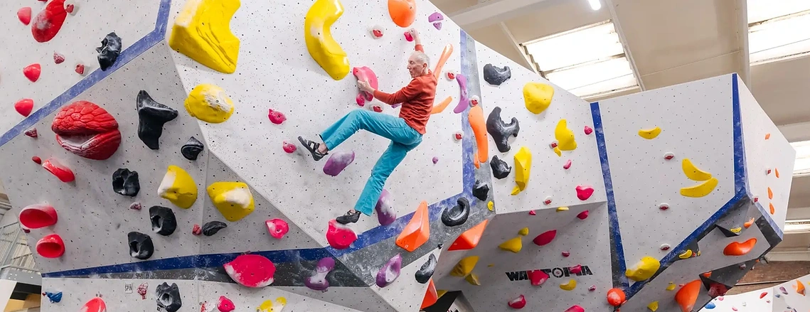 Creative commercial photography documenting indoor climbing wall activity during a civic marketing shoot.