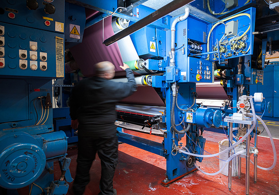 Ambla manufacturing facility case study cover image by Steven Longbottom shows man operating vintage machinery
