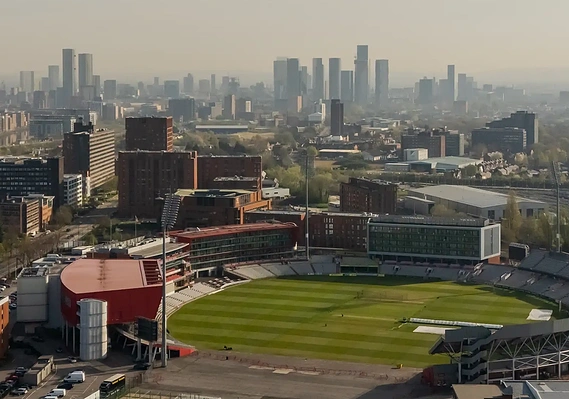 Location photography capturing cricket ground from drone and showing Trafford, architecture of manchester in background, shot for a destination marketing campaign.