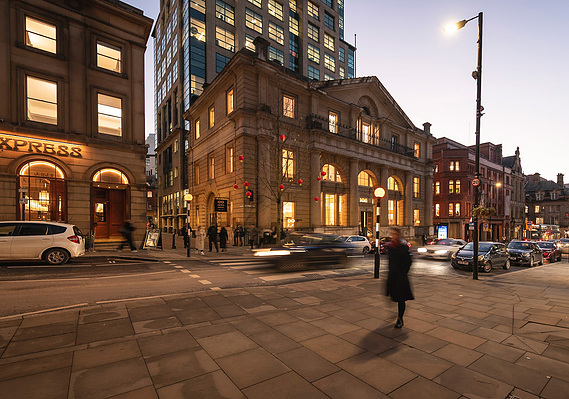Case Study Photography Cover For Authentic Brand + Commercial Lifestyle Photography For Leading Manchester Optician showing exterior of building at night
