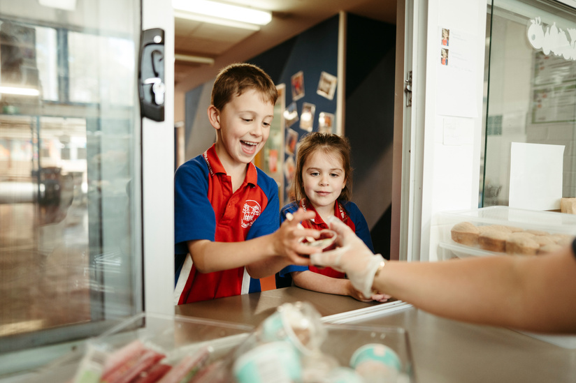 Students Chelsea 5, and Cooper Todd 8 receive food at the Miles Franklin Primary School canteen. Picture: Dion Georgopoulos - THE CANBERRA TIMES, ACM