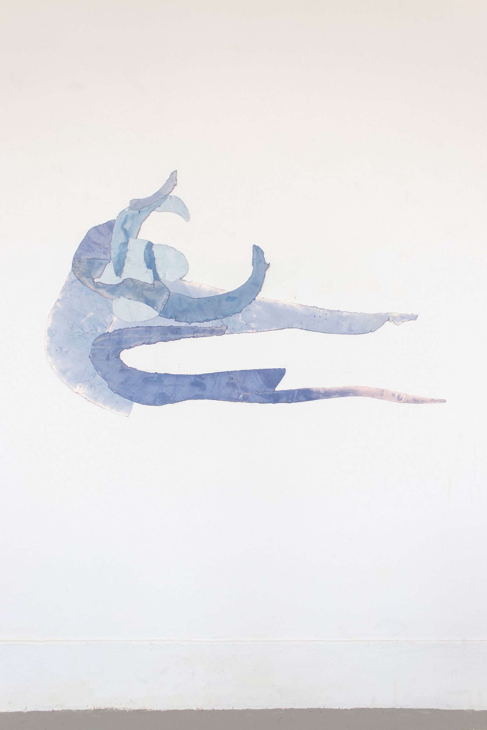Jumping figure made from paper object hanging on a wall. Jamie Kane