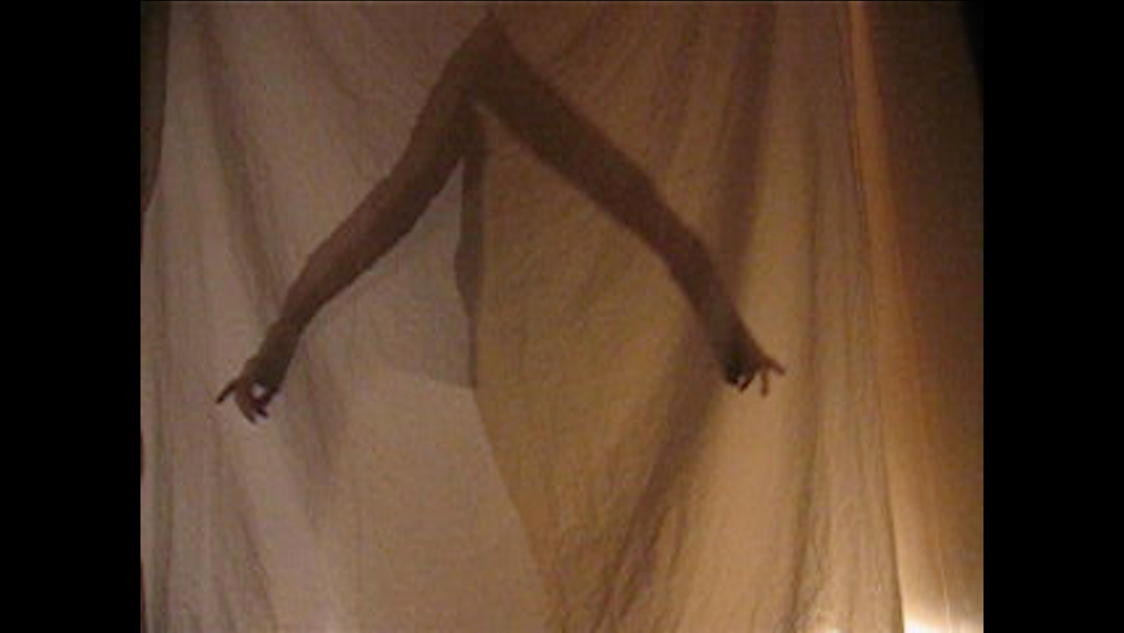 The shadow of someones arms seen through an off white fabric. Jamie Kane