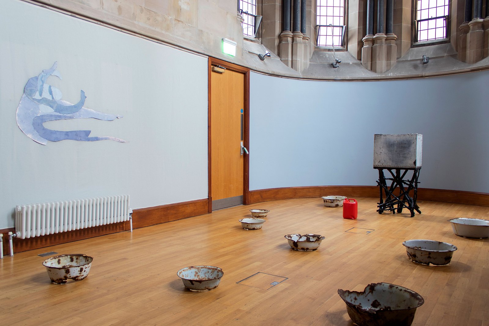 Blue curved chapel with painting and sculpture. Jamie Kane