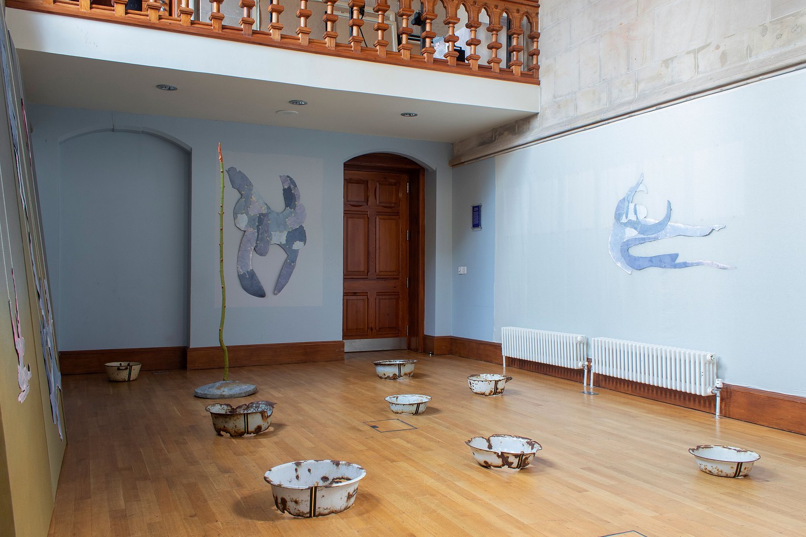 Blue curved chapel with painting and sculpture. Jamie Kane