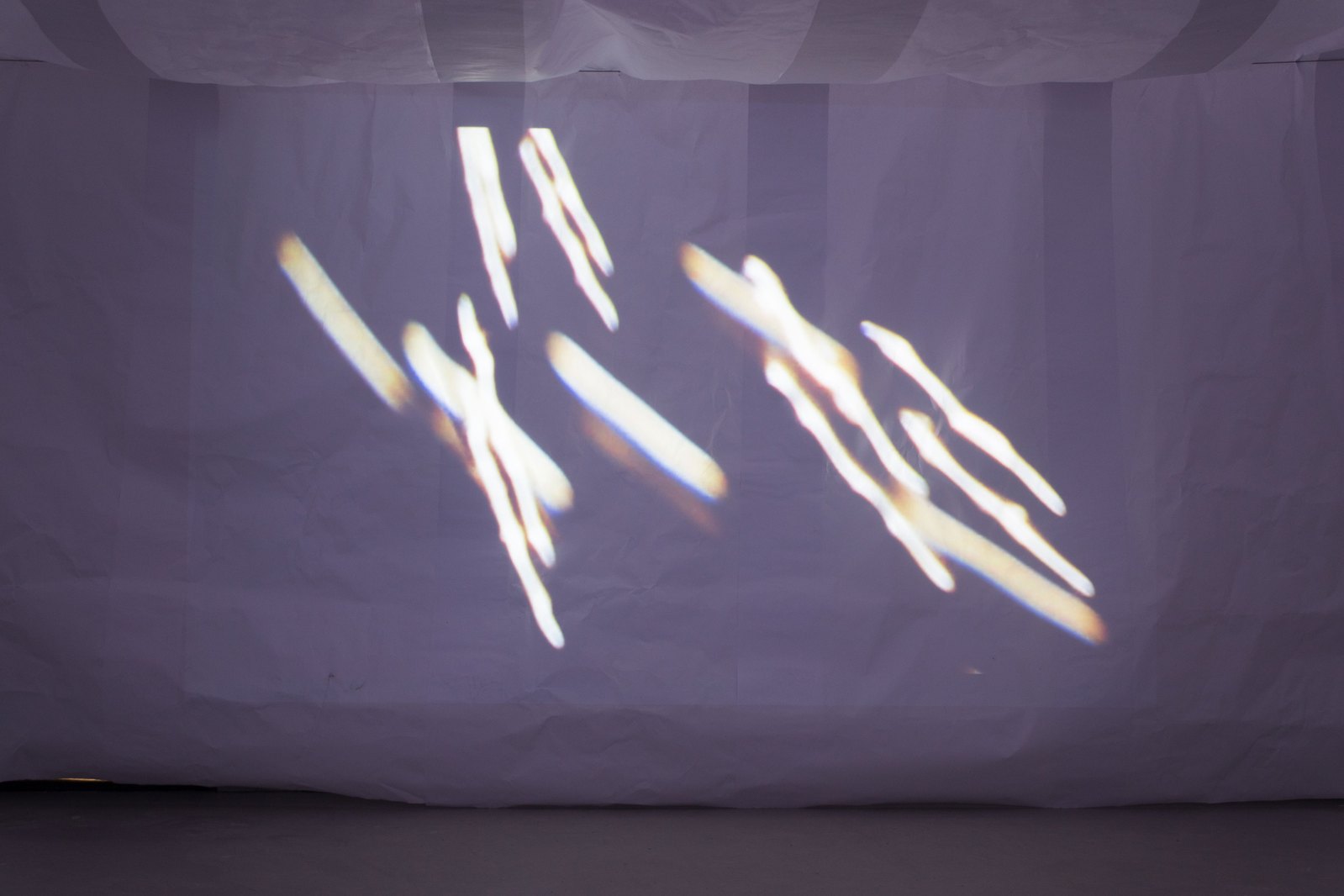 Projection onto paper showing sparks of light. Jamie Kane