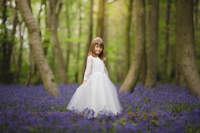Holy Communion photography in London – elegant outdoor portrait of a child celebrating their First Communion in traditional attire