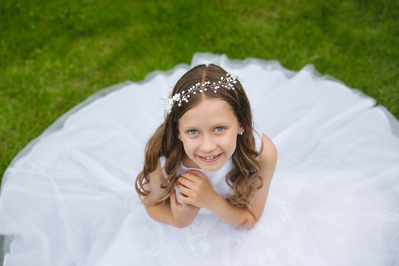 Holy Communion photography in London – elegant outdoor portrait of a child celebrating their First Communion in traditional attire