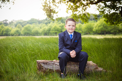 Natural light portrait of a boy on his First Holy Communion day, photographed in North East London. Specialising in Holy Communion photography for families across London and surrounding areas.