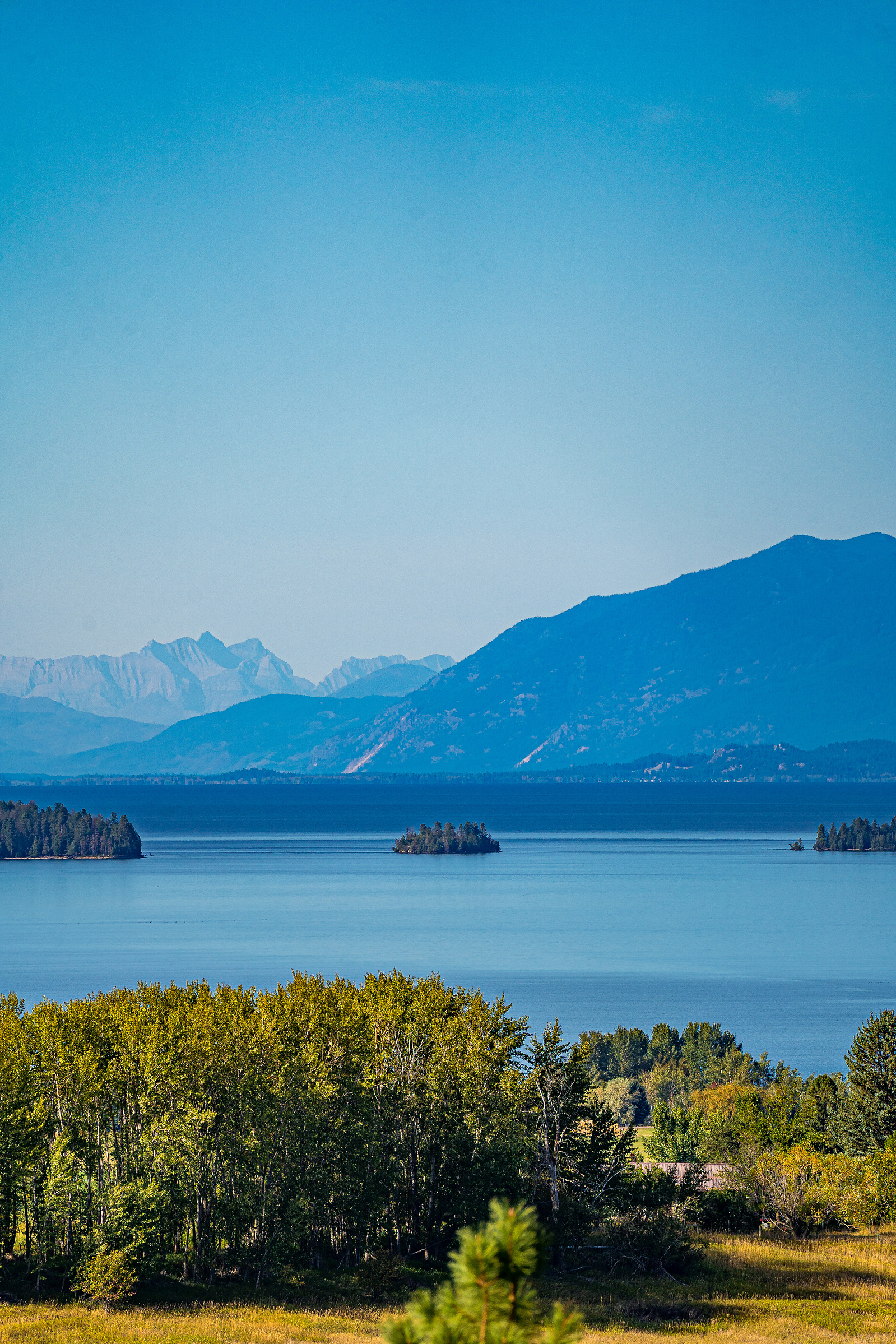 Small island on Flathead Lake, Montana with mountains in the background.