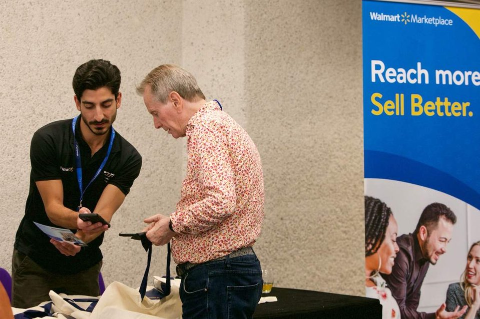 Staff help a delegate registering with Walmart at their London conference