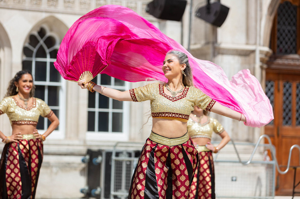 Bollywood style dancers perfrom at an outdoor event