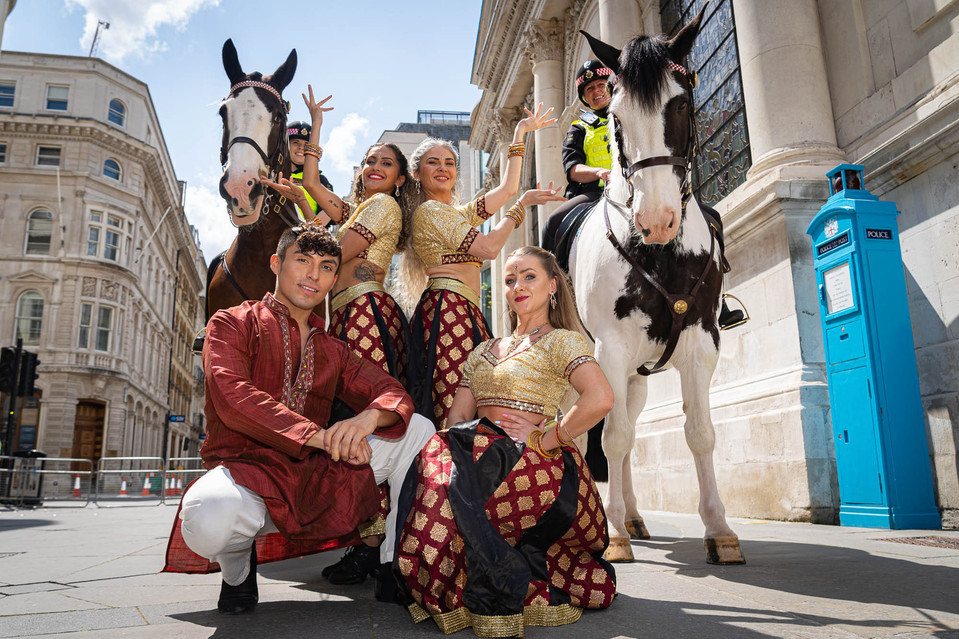 Dancers pose with police horses