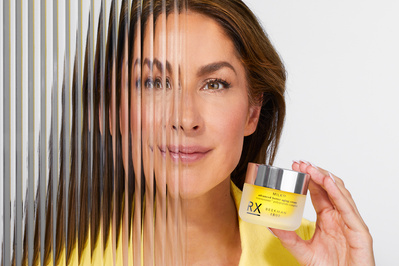 advertising photography of Beekman 1802 anti-aging face cream product being held by middle-aged model