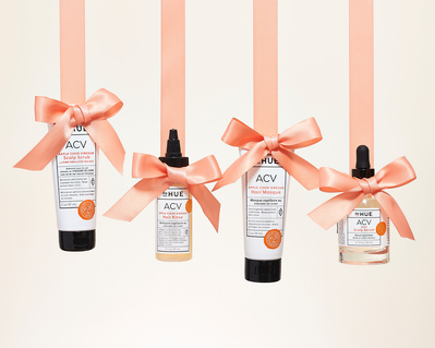 holiday campaign image with DP Hue haircare products and pink orange ribbon
