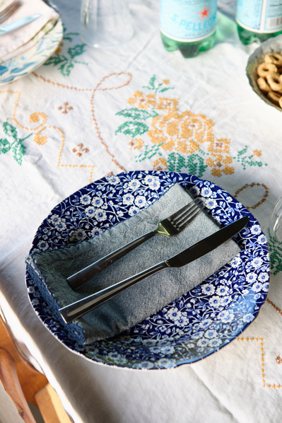 beautiful tablescape setting with blue floral plate and vintage white embroidered table cloth
