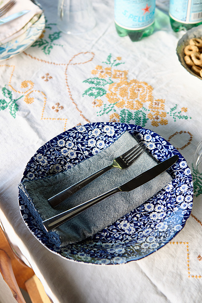 beautiful tablescape setting with blue floral plate and vintage white embroidered table cloth