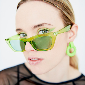 Fashion: Girl in green sunglasses and black mesh top