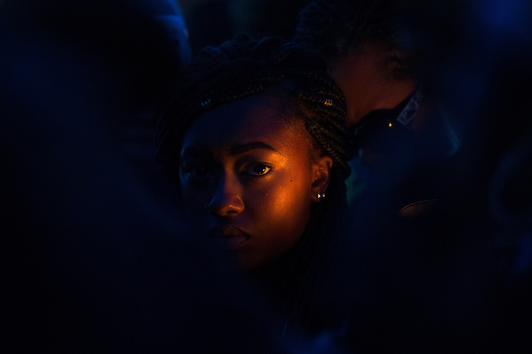 Iriana Jackson's face is illuminated by the light of a candle during a vigil honoring her friend, Destacia Straughn, and Straughn's 2-year-old daughter, Kenacia, on Tuesday, December 8, 2015, in Omaha, Nebraska. The mother an