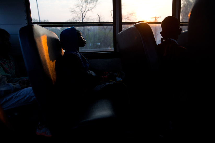 OMAHA, NEB., -- 04/14/2016.All Saints Catholic 4th-grade student Noel Eremti rides the school bus as the sun comes up in Omaha, Neb., on Thursday, April 14th, 2016. MEGAN FARMER/THE WORLD-HERALD