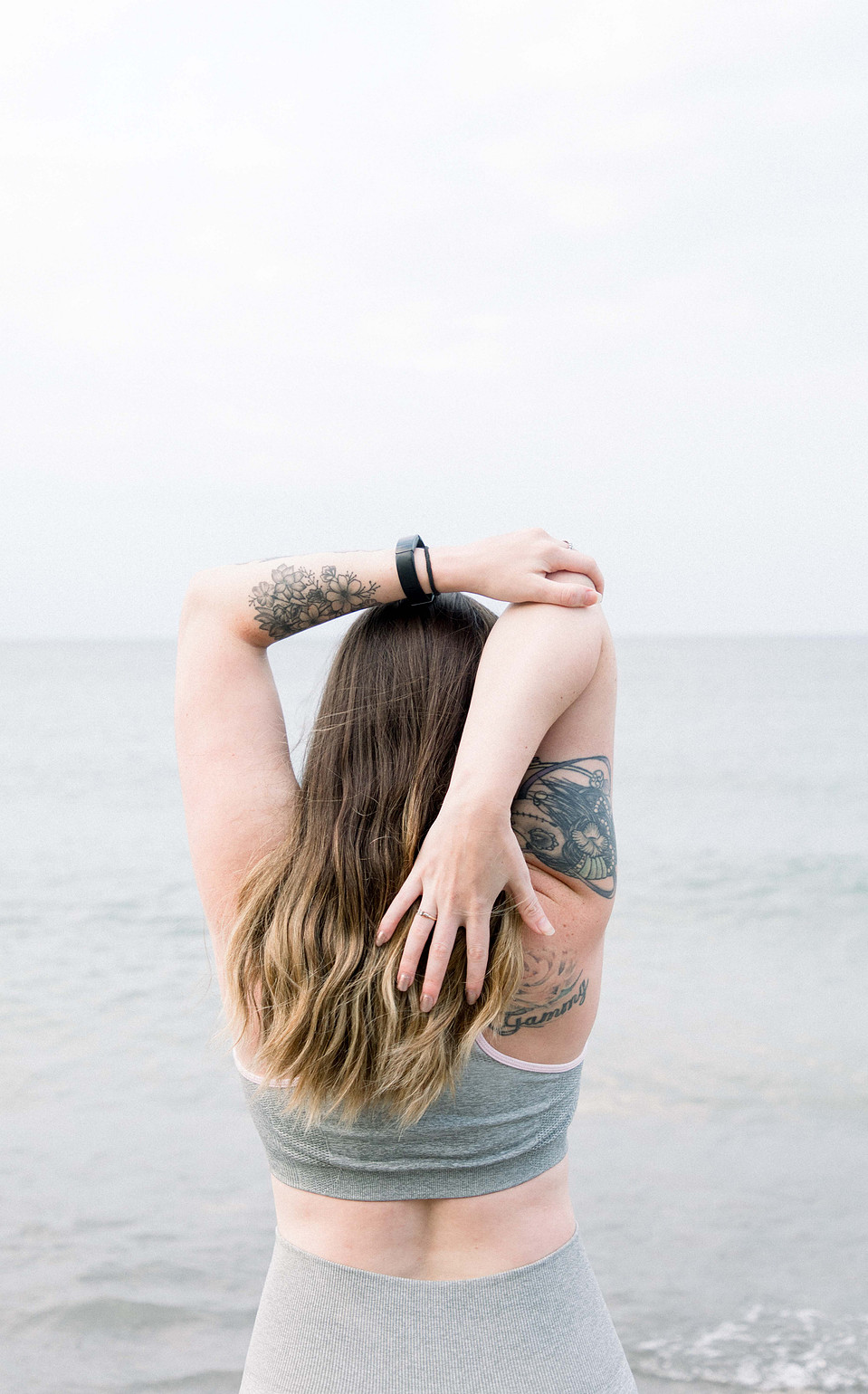 Portrait of a female fitness model stretching her arms behind her head, Niagara portrait photographer, Niagara branding photographer